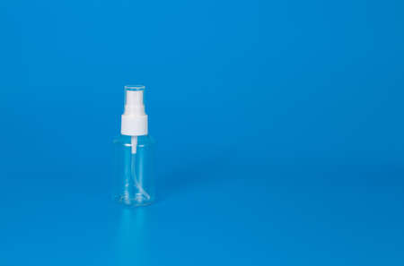 A bottle of spray on a blue background.の写真素材