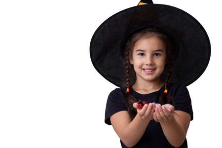 A girl in black clothes and a black cap on white backgroundの写真素材