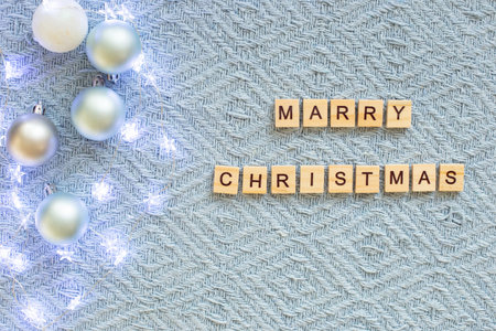 Blue knitted blanket with Christmas balls and a star figurine.の写真素材