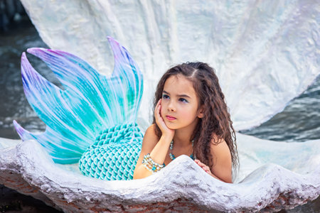 A beautiful girl in a mermaid costume in a large sea shellの写真素材