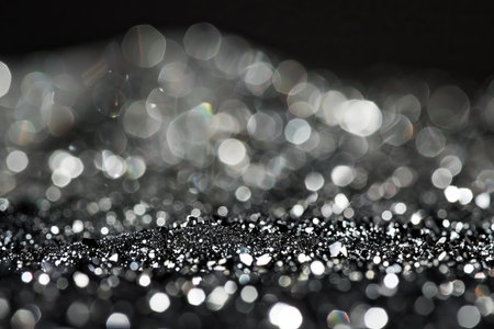 Sparkling silver and black bokeh abstract background with blurred lightsの素材