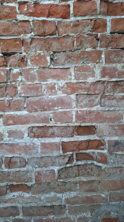 Old red brick wall with weathered texture and mortar detailingの写真素材