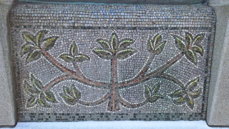 Intricate leaf patterned mosaic artwork on stone surfaceの写真素材
