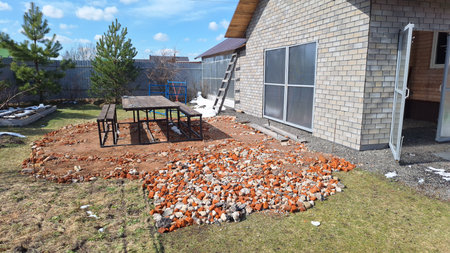 Outdoor brick patio with picnic table and wooden houseの写真素材