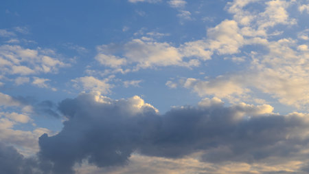 Serene sky with fluffy clouds at duskの写真素材