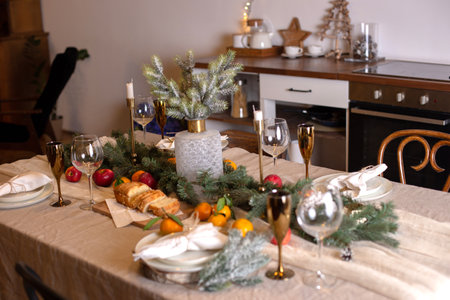 Christmas table with serving and decor with spruce branchesの写真素材