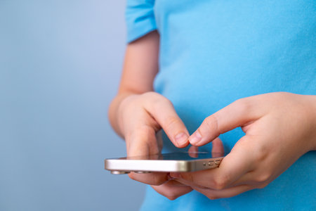 Child using smartphone for gaming or communication close-upの写真素材