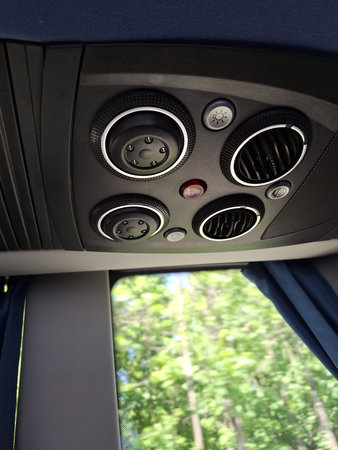Air vents and controls inside vehicle with trees visible through windowの写真素材
