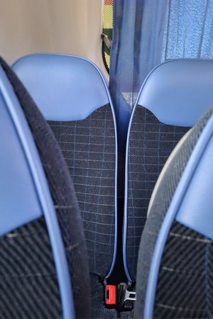 Modern blue and black interior of bus seats with comfort and safety functionsの写真素材