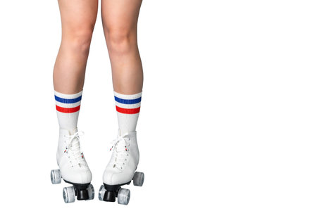 Female caucasian legs in roller skates and striped socks on white backgroundの写真素材
