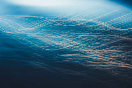 Close-up of water texture, smooth blue waves of water on the shore beach, color landscape photo of waterの写真素材