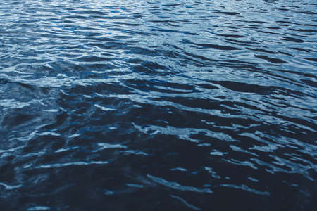 Close-up of water texture, smooth blue waves of water on the shore beach, color landscape photo of waterの写真素材