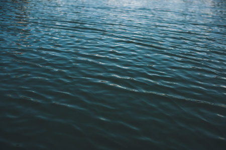 Close-up of water texture, smooth blue waves of water on the shore beach, color landscape photo of waterの写真素材