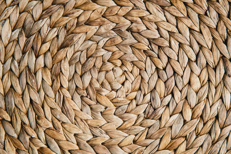 Straw wicker abstract background, straw wicker beige eco friendly spiral abstract background spaceの写真素材