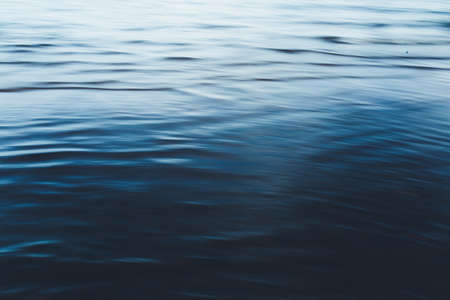 Close-up of water texture, smooth blue waves of water on the shore beach, color landscape photo of water.Smooth and beautiful waves on the beach. The texture of the water in Icelandの写真素材