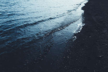 Close-up of water texture, smooth blue waves of water on the shore beach, color landscape photo of water.Smooth and beautiful waves on the beach. The texture of the water in Icelandの写真素材