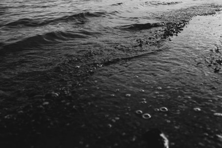 Close-up of water texture, smooth waves of water on the shore, landscape photo of water