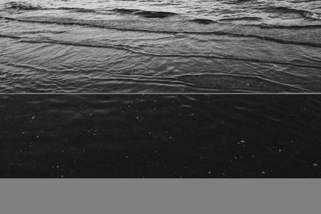 Close-up of water texture, smooth waves of water on the shore, landscape photo of water