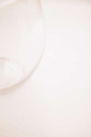 Beautiful photo of a glass vase, abstract glass texture. Beige and neutral background. Transparent glass surface, beautiful reflections and reflectionsの写真素材