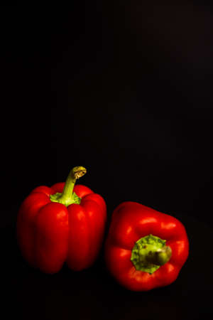 Fresh vegetables, red peppers on a black backgroundの写真素材