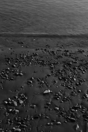 Close-up of water texture, smooth waves of water on the shore, landscape photo of waterの写真素材