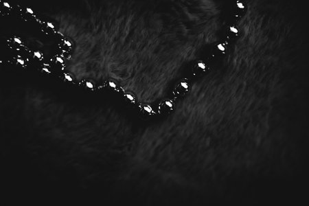Christmas composition, new year concept. Beautiful silver Christmas beads on a dark fur background. Flat lay, top view, copy spaceの写真素材
