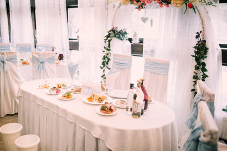 Color photo of the reception and banquet at the wedding, a beautiful wedding table with original food and snacks for the holidayの写真素材