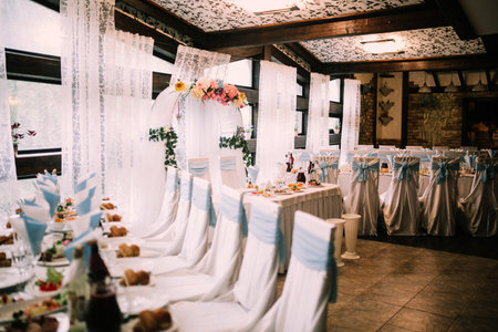 Color photo of the reception and banquet at the wedding, a beautiful wedding table with original food and snacks for the holiday