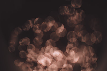 Golden abstract bokeh on black background. Holiday concept