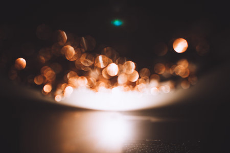 Golden abstract bokeh on black background. Holiday concept