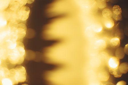 Golden abstract bokeh on black background. Holiday conceptの写真素材