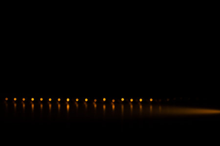 Minimalistic photography, orange beads lined up, geometry and perspective of round objectsの写真素材