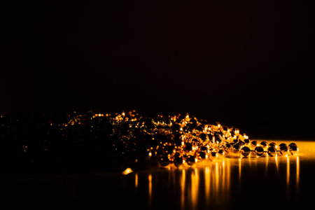 Golden christmas garland, abstract background and texture beads close up. Holiday conceptの写真素材