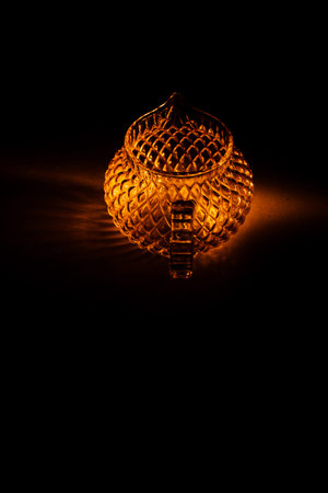 color photo of a glass vessel for a tea ceremony, close-up of the glass texture illuminated with a...