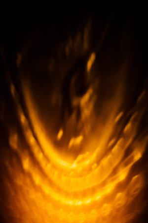 abstract pattern on the wall, beautiful orange shadows on the dark wall from the play of lantern...
