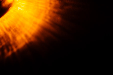 abstract pattern on the wall, beautiful orange shadows on the dark wall from the play of lantern raysの写真素材