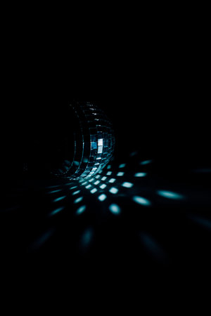 Color photo of a disco ball with blue lighting, a close-up play of light and shadow. Christmas and...
