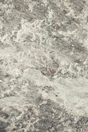 Stone light background, texture and structure of mountain landscape close-up in summer