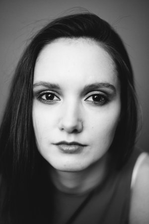 studio black-and-white portrait of a brunette girl, emotions on the face of a young woman, diverse close-up portraits and hand gesturesの写真素材