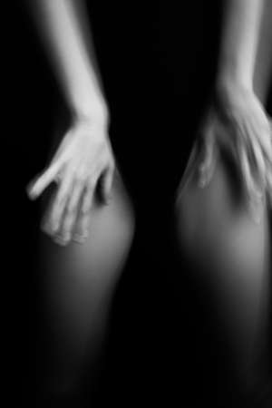 details of the body, hands on black background close-upの写真素材