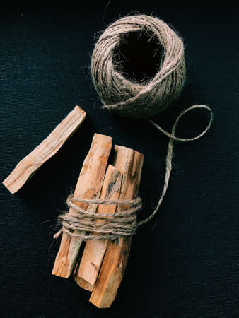 Scattered sticks of Palo Santo tree on a dark background. Top view. Organic holy tree incense from Latin America. Color photo close-up of natural frankincense.の写真素材