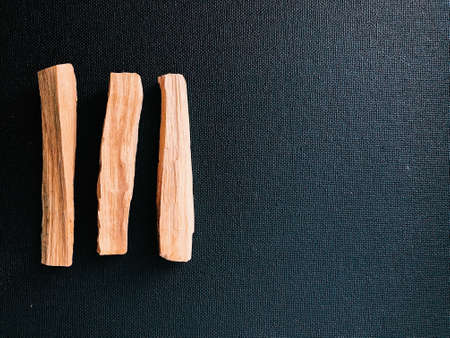 Scattered sticks of Palo Santo tree on a dark background. Top view. Organic holy tree incense from Latin America. Color photo close-up of natural frankincense.の写真素材