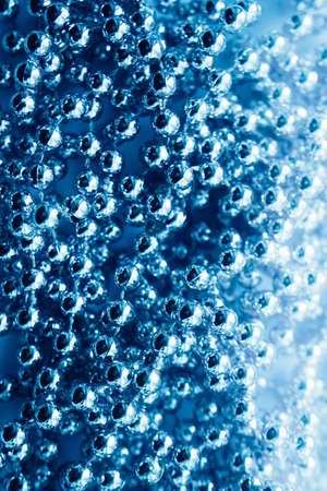 abstract blue background, garland of blue metal round beads.new year and christmas concept, place for textの写真素材
