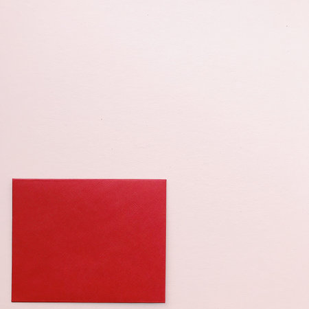 Red envelope on a neutral background. Postal composition, top view, space for text. The concept of...