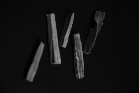 Natural incense Palo Santo. Sacred tree of South America, color square photo. Palo Santo on black...