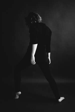 fashionable dark art photography, full-length portrait of an impersonal person in a studioの写真素材