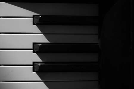 piano keys, play of light and shadow, abstract background musicの写真素材