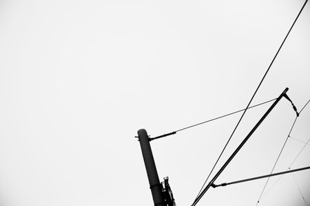 Black and white urban landscape. Electric wiring of trains and trains close-up