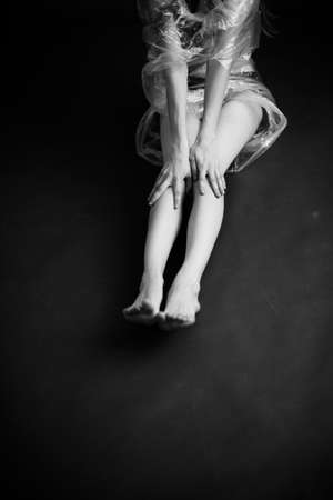 beautiful female legs, black and white portrait of human body parts, fuzzy and noisy film photography, art and fashionの写真素材