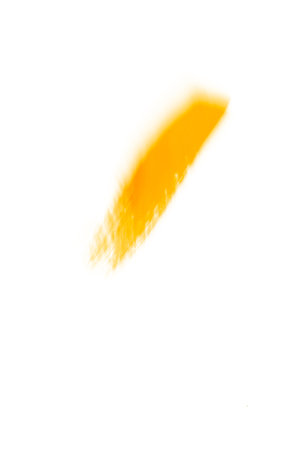 Gold acrylic brushstroke isolated on a white background.の写真素材